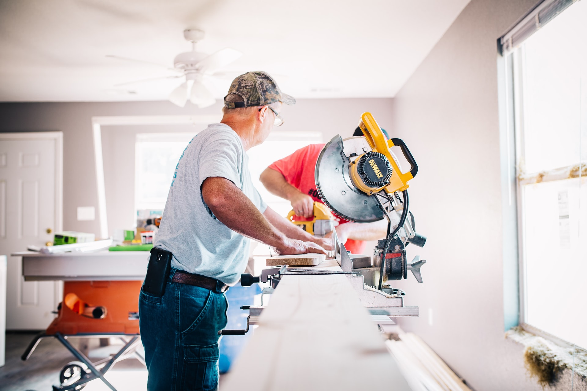 man doing carpentry in a home that is being renovated